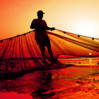 A fisherman working on a beach in Karachi